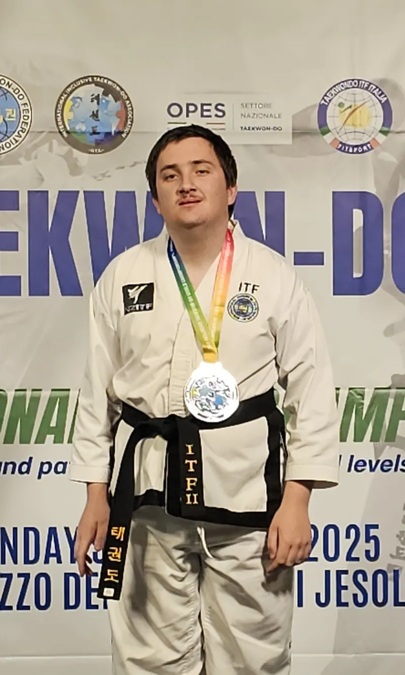 A New Zealand black belt athlete wearing a silver medal at the World Championships in Italy